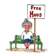 old woman on a bench with a sign saying "free hugs"